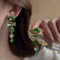 A pair of retro green gradient tassel earrings with inlaid zircon stones in a Chinese geometric style.