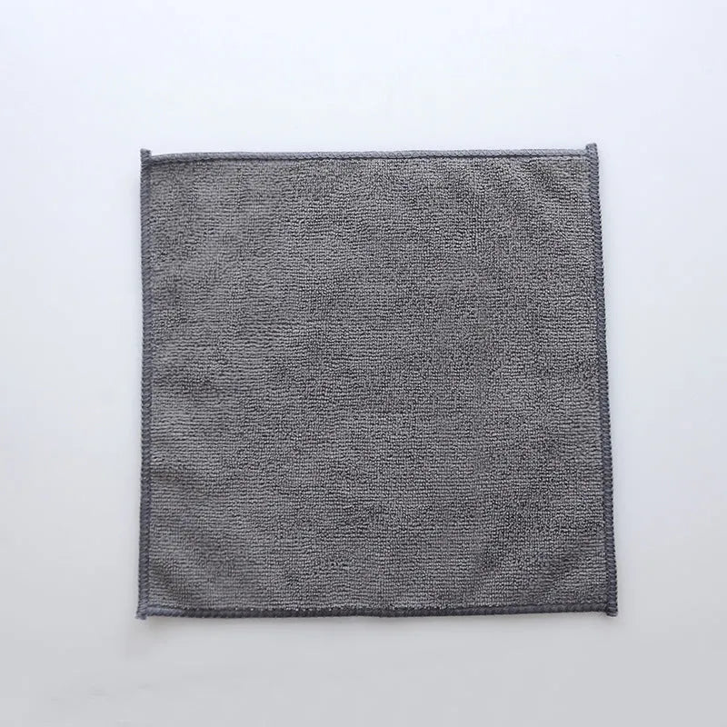 Grey square microfiber kitchen cleaning cloth for oil and grime on pots and bowls.
