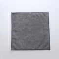 Grey square microfiber kitchen cleaning cloth for oil and grime on pots and bowls.