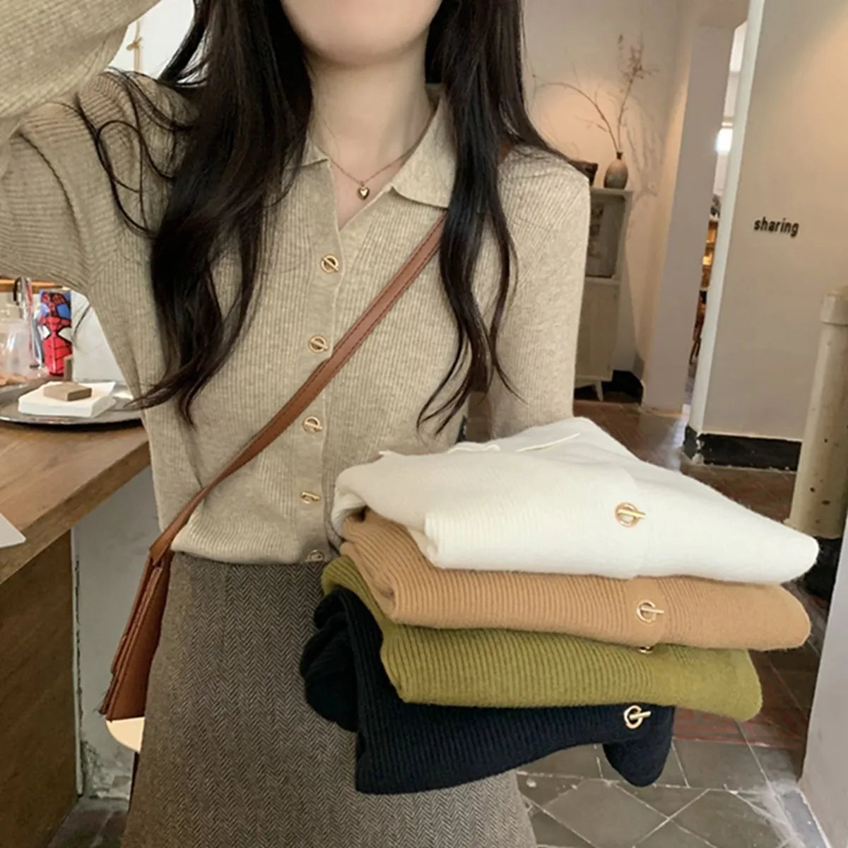 Long-sleeved beige viscose knit cardigan top shown on a hanger, demonstrating its loose fit and regular sleeve length.