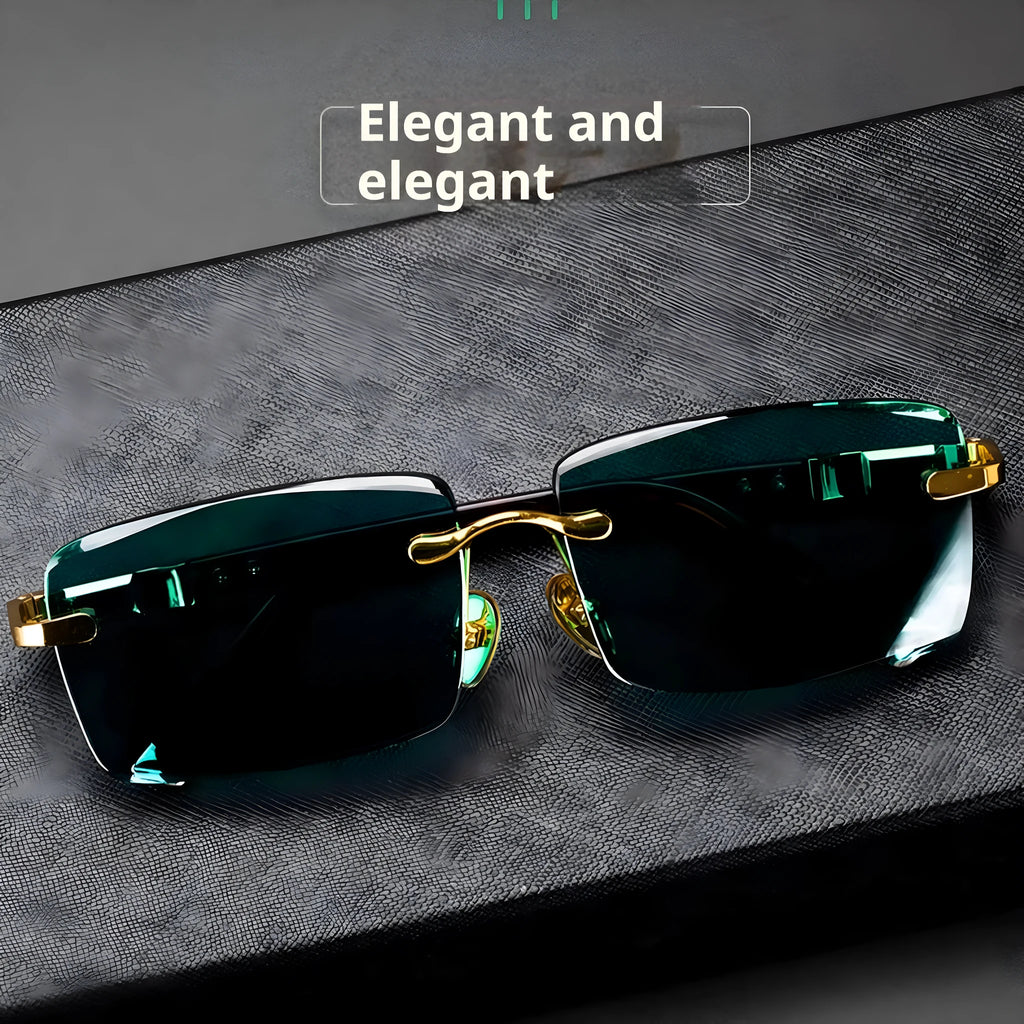 A pair of frameless dark green crystal sunglasses with a hard case and lens cloth.