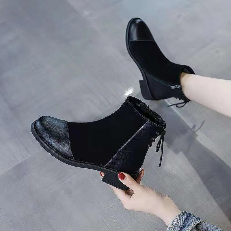 Black women's knee-high Martin boots with side zipper and round toe.