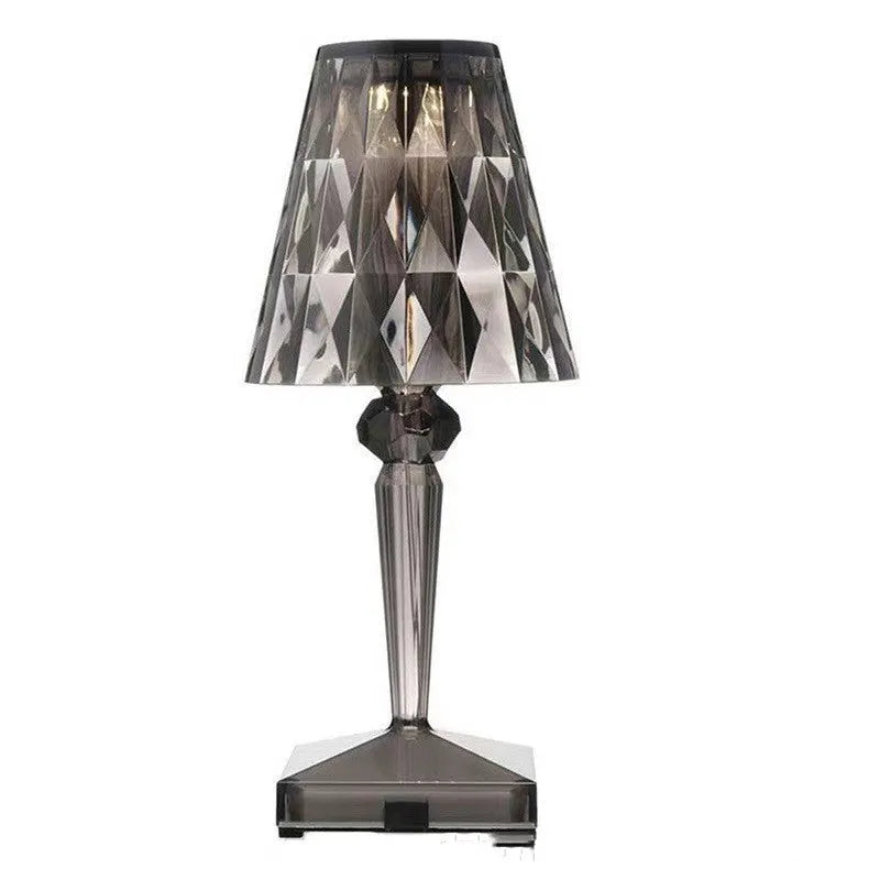 Portable rose gold touch control night light with acrylic lamp holder on a table.