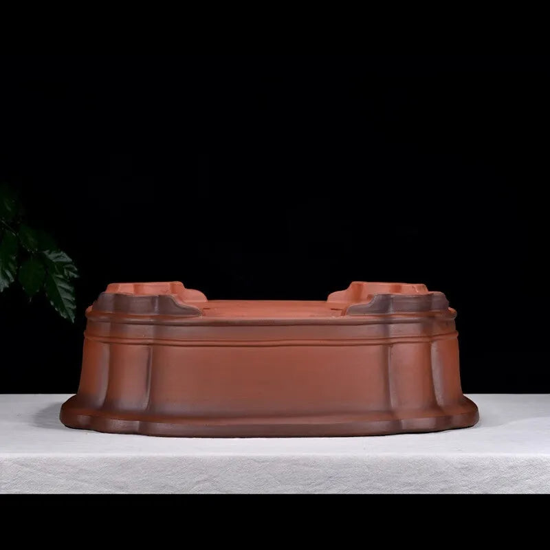 Large antique-style purple clay flowerpot with Chinese design for outdoor garden use.