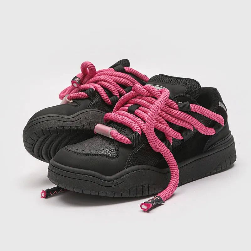 Pair of low-top unisex casual lace-up shoes with a thick rubber sole, shown in a solid colour.