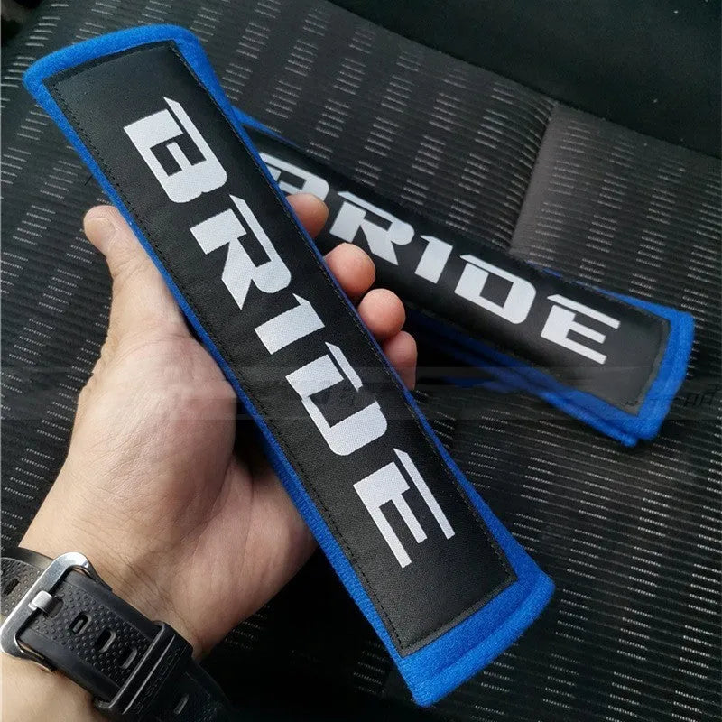 Black car seatbelt shoulder pad made of sponge cloth and cotton, showing embroidery weave detail.