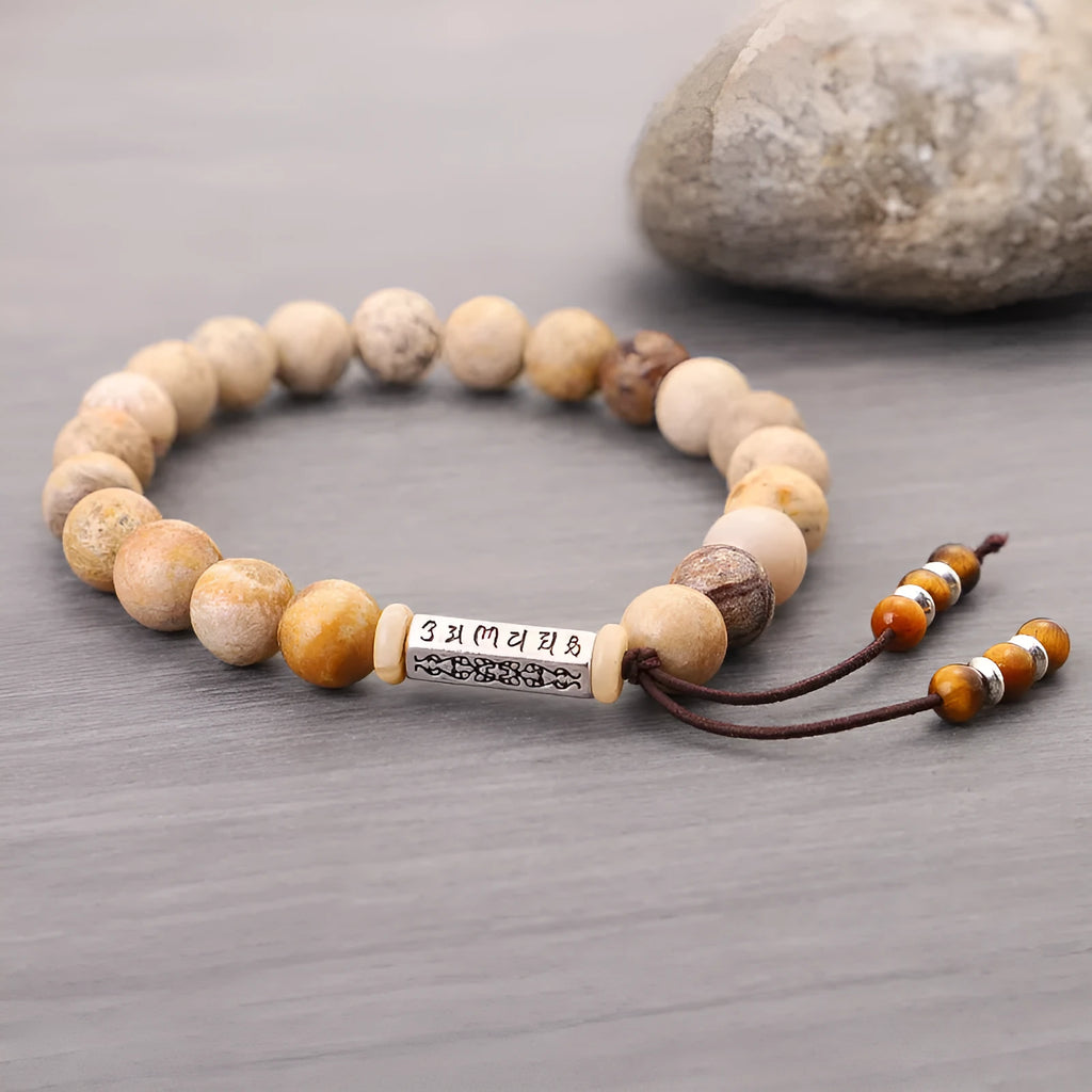 Handmade wood-colour stone bracelet with retro design on a wrist.