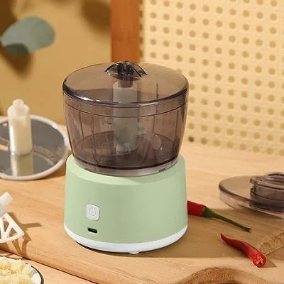 Mini meat grinder with transparent cup body, stainless steel blade, and USB rechargeable port in white colour