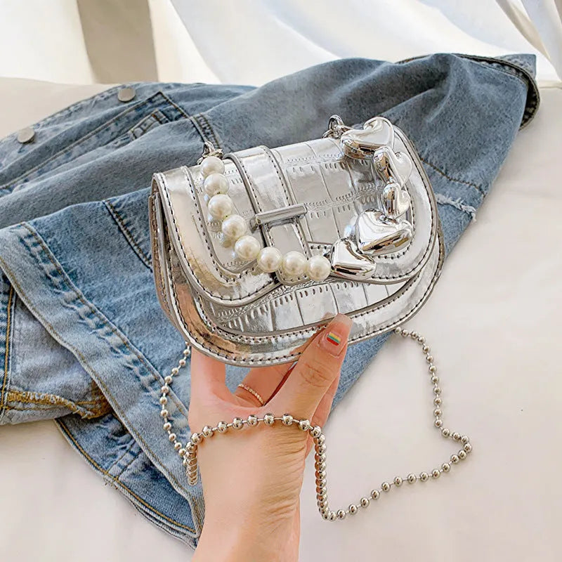 Mini crossbody bag in PU leather with mobile phone pocket, shown in silver colour with horizontal square design