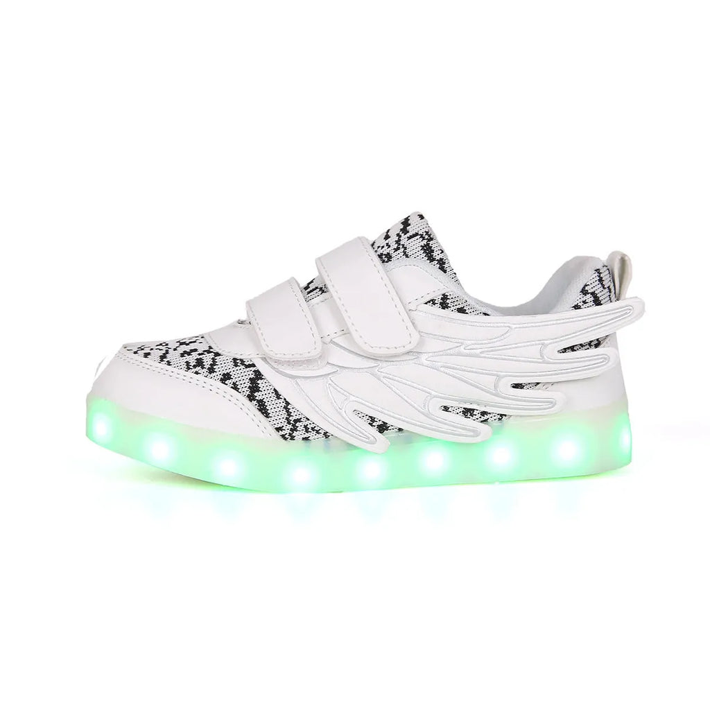 Children's plum red and white sneakers with colourful LED lights glowing on the side.