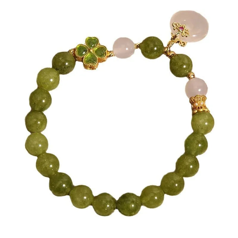Natural stone green tourmaline women's bracelet with peace buckle and lucky bag charm on display