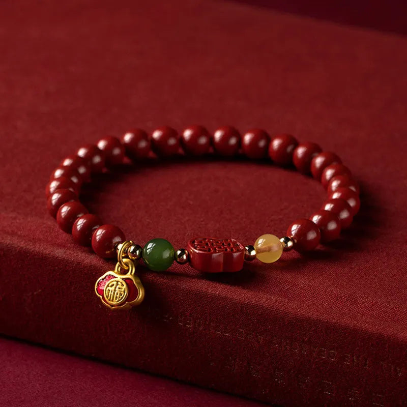 Happy Eyebrow Bracelet made of cinnabar with Emperor Sandstone beads and fu character charm.