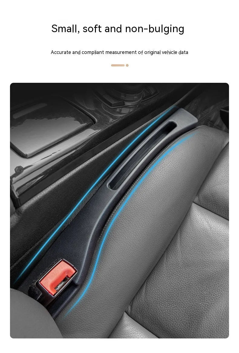Black plastic car seat gap storage box with handle inserted between vehicle front seats.