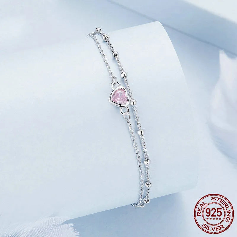 Sweet girlish sterling silver bracelet with a small heart-shaped pendant on an adjustable chain.