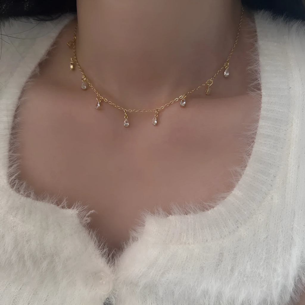 Zircon jewellery set with geometric necklace, earrings and anklet featuring meteor shower design elements