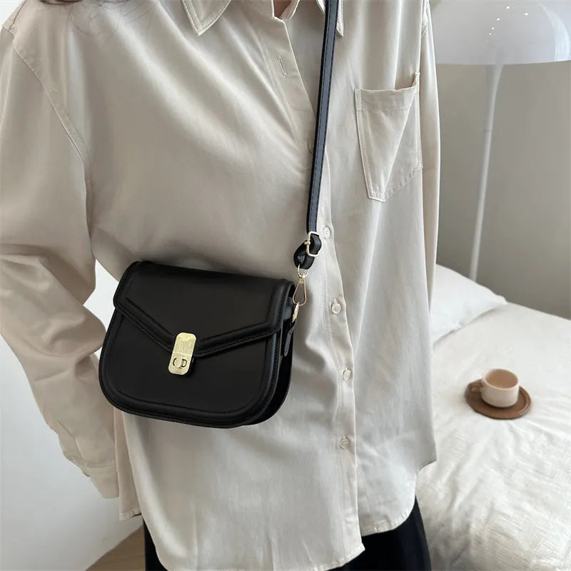 Soft PU leather clamshell shoulder messenger bag in horizontal square shape.