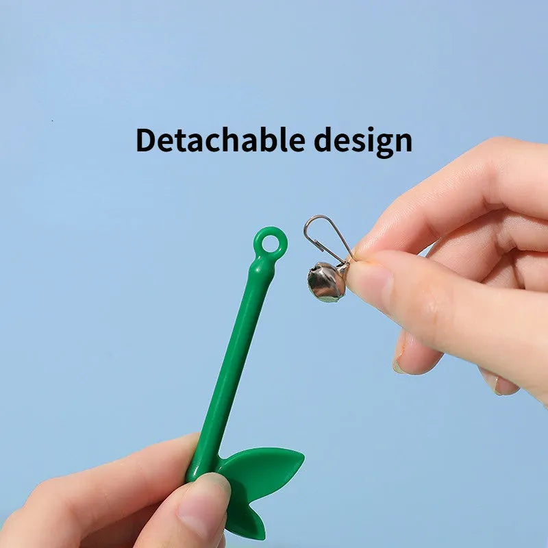 Green interactive cat feather wand toy with bells on a light background