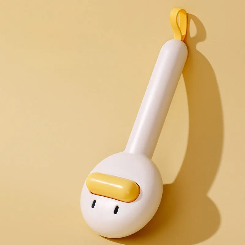 Small yellow duck-shaped pet grooming comb with needle head for hair removal on cats and dogs.