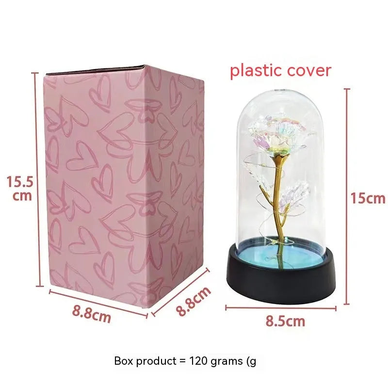 Small plastic night lamp with coloured LED lights and a decorative flower design under a glass-style cover.
