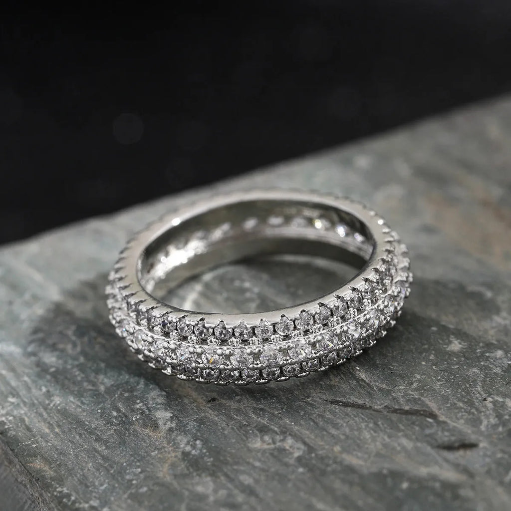 Geometric personalised engagement ring with triangular zircon stone on a copper band.