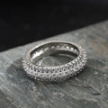 Geometric personalised engagement ring with triangular zircon stone on a copper band.