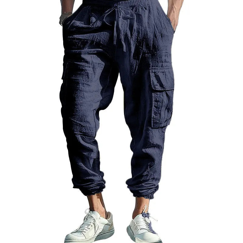 Men's loose-fit linen trousers with ankle ties and multiple pockets in Army Green.