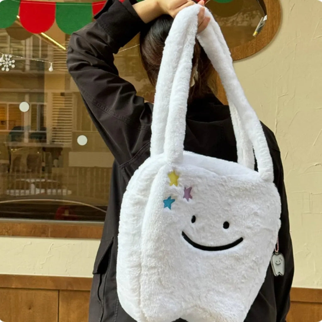 White plush large tooth design shoulder tote bag with a zipper, shown as a unisex crossbody bag.