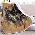 Brown Sherpa fleece throw blanket with wolf head pattern on a couch