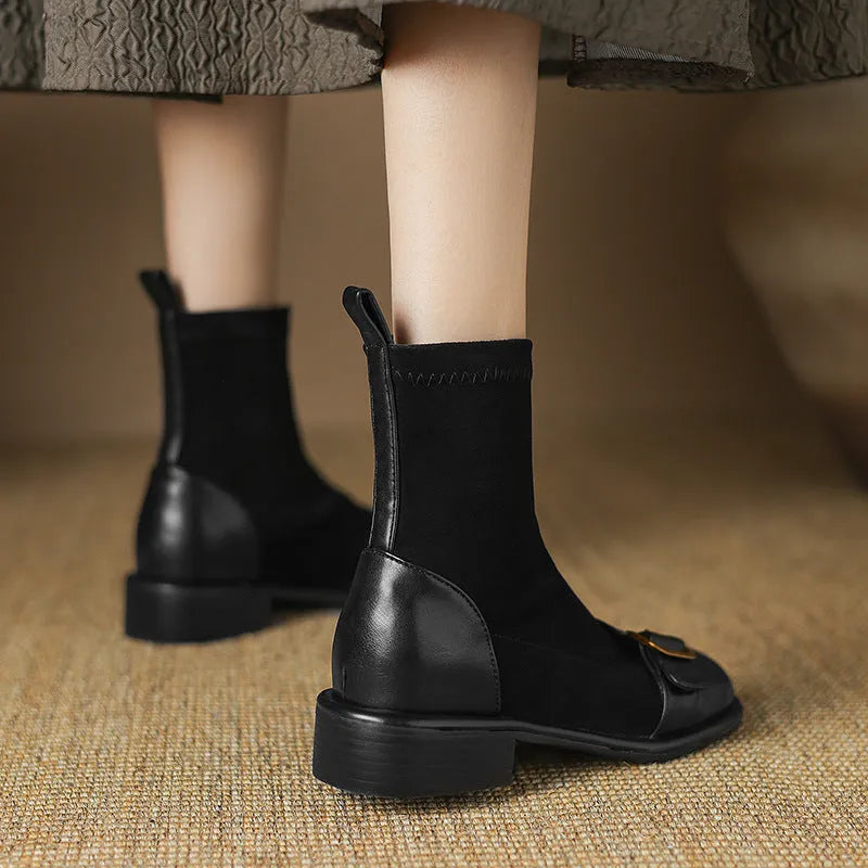 Black women's Martin-style ankle boots with lace-up front, round toe, and low heel on a white background.