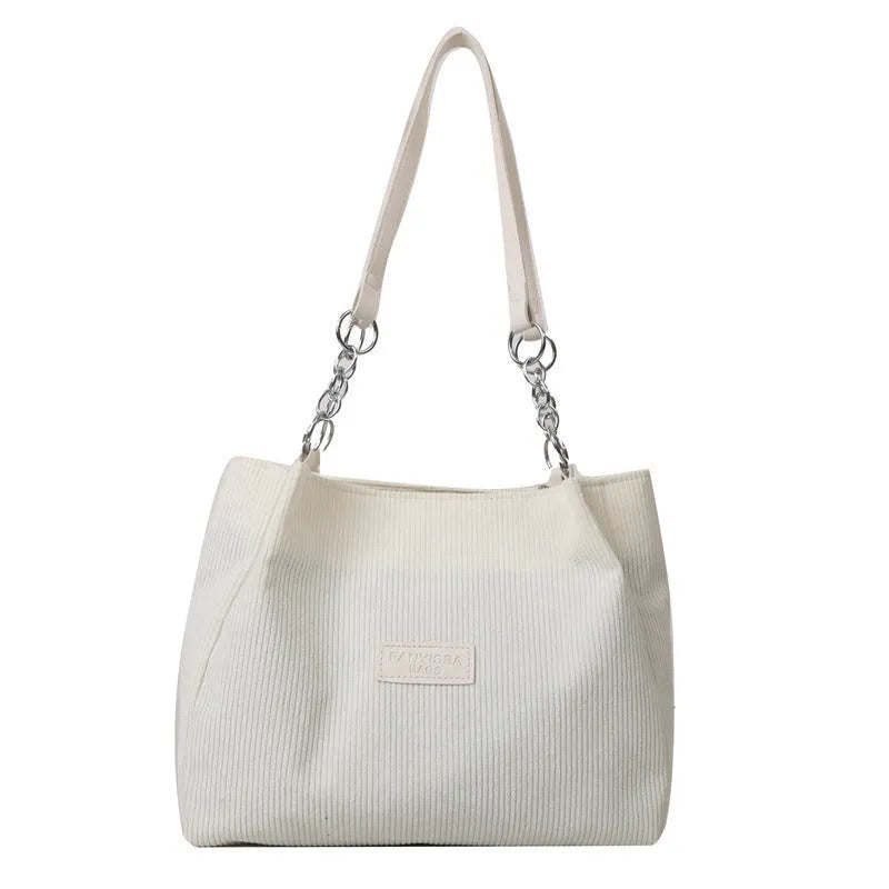 Corduroy one-shoulder large capacity tote handbag for women in black, brown, and white with outer pocket