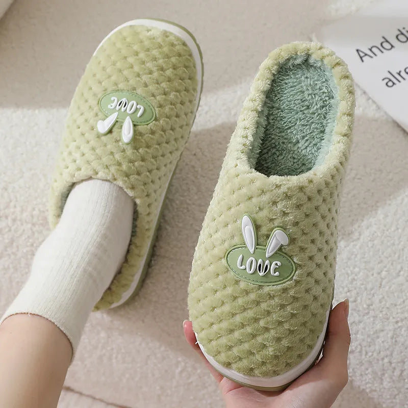 Women's rabbit plaid design artificial fur house slippers with a thick non-slip rubber sole.