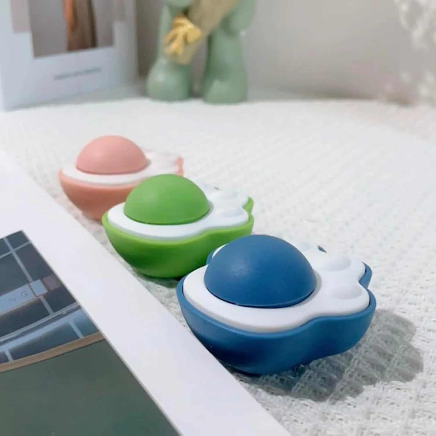Blue, green, and pink mouse-shaped catnip chew ball toy with edible vine and plush fabric.