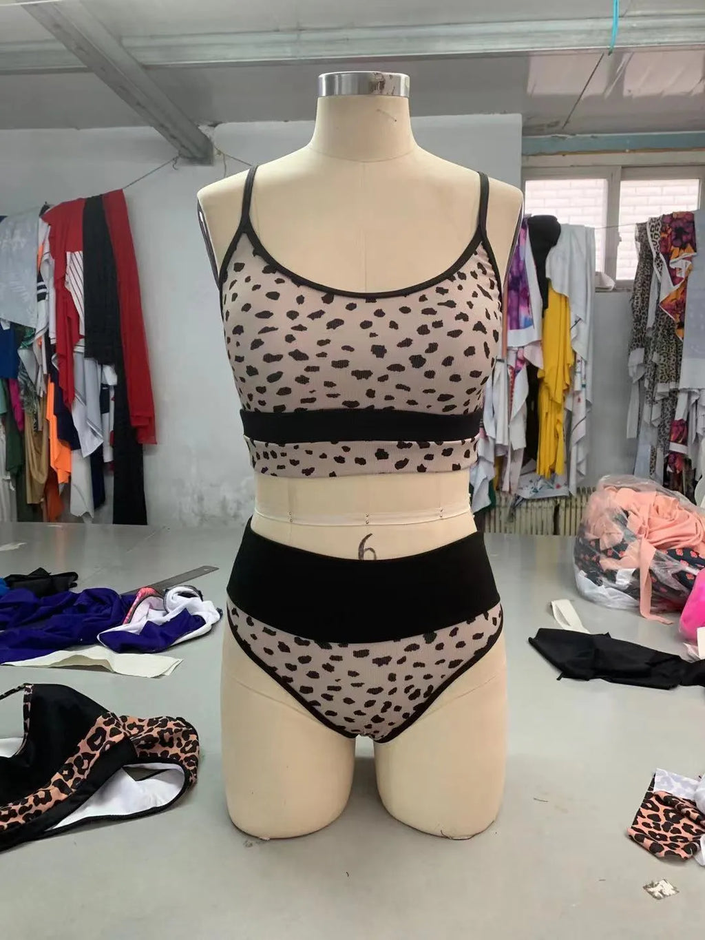 Women's high waist leopard print and white bikini swimsuit set on a mannequin