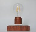 Magnetic levitation floating bulb lamp with ABS glass construction on imitation wood base