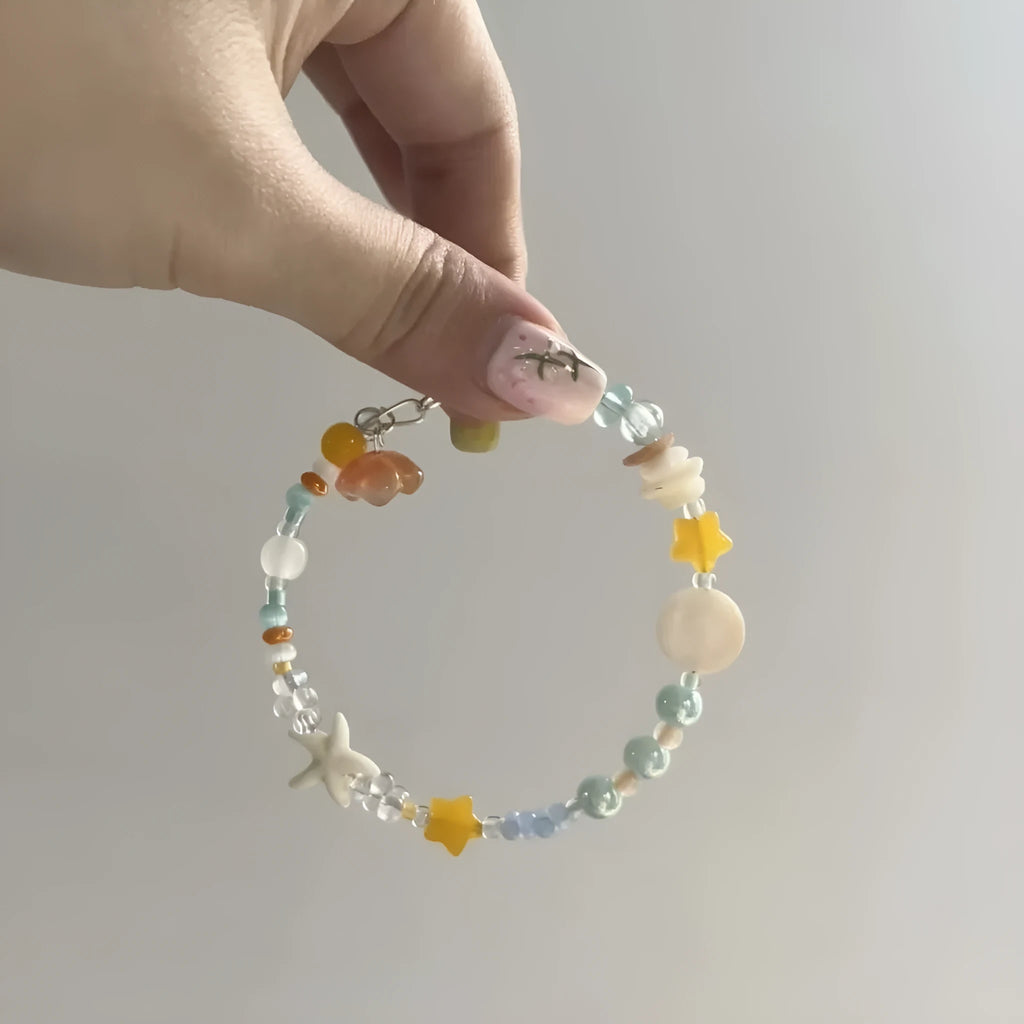 Orange alloy bracelet with diamond-shaped links and mixed material construction