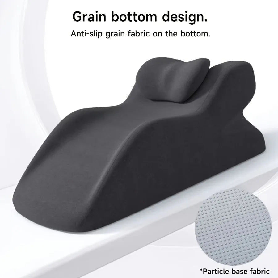 A stomach sleeper pillow in blue, designed for prone positioning and reading in bed.