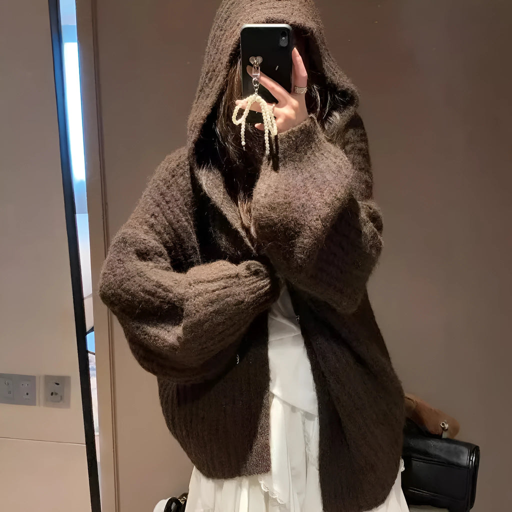 Women's dark grey loose-fit hooded cardigan sweater with chunky acrylic knit texture.
