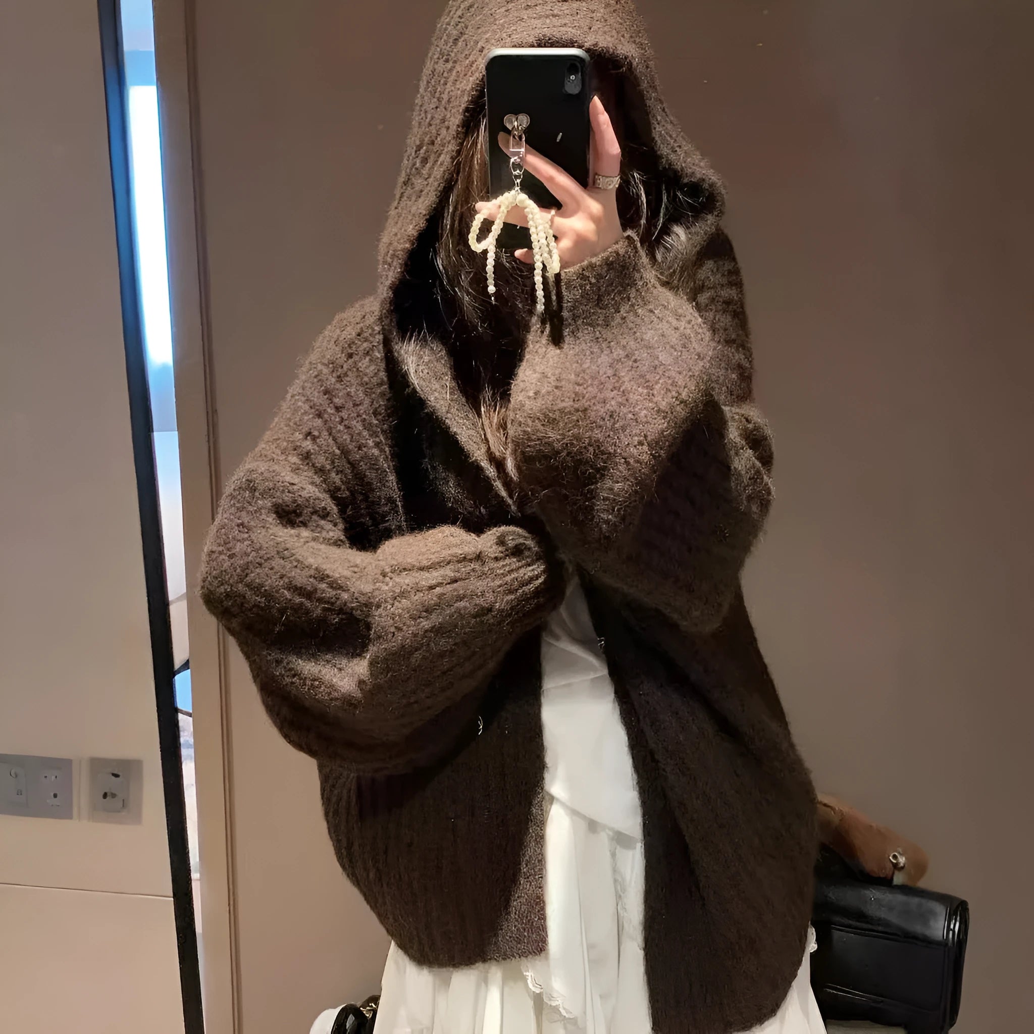 Women's dark grey loose-fit hooded cardigan sweater with chunky acrylic knit texture.