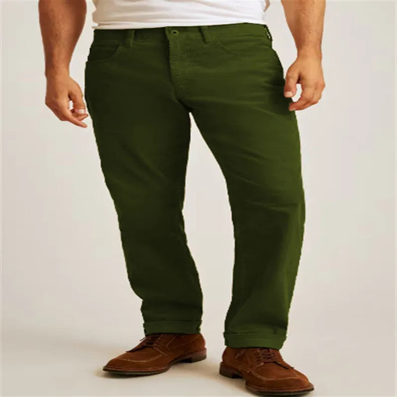 Straight leg corduroy trousers in army green colour, showing loose fit and zip fly detail.