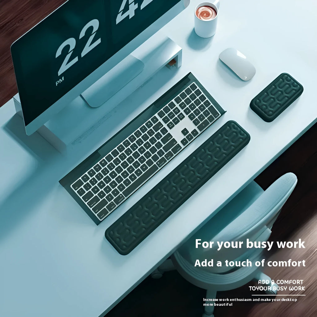 Memory foam keyboard and mouse pad with wrist rest in various colours on a desk