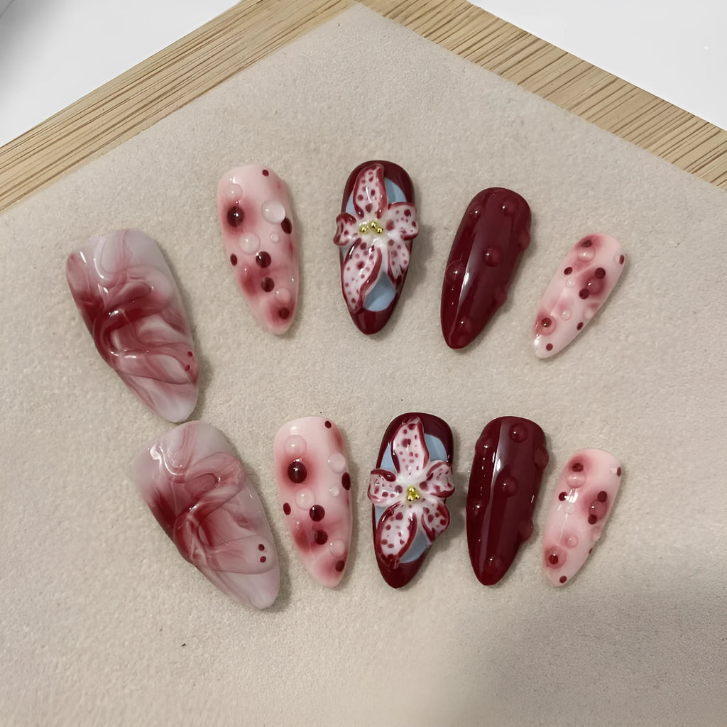 False nails with 3D carved floral and decorative patterns in almond shape, showing size options