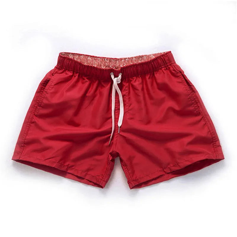 Man wearing soft polyester beach shorts in a straight-leg style, available in multiple colours and plus sizes.