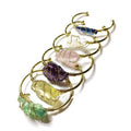 Geometric gold wire bracelet with a central rough natural crystal, bohemian ethnic style.