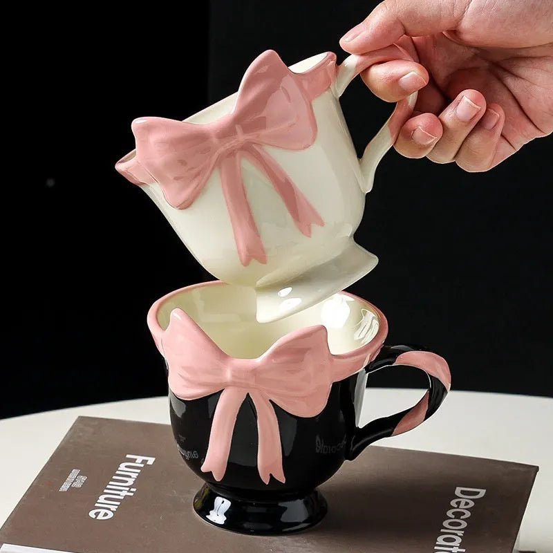 Ceramic mug with girl heart bow decoration in white powder or black pink colour, 301-400ml capacity.