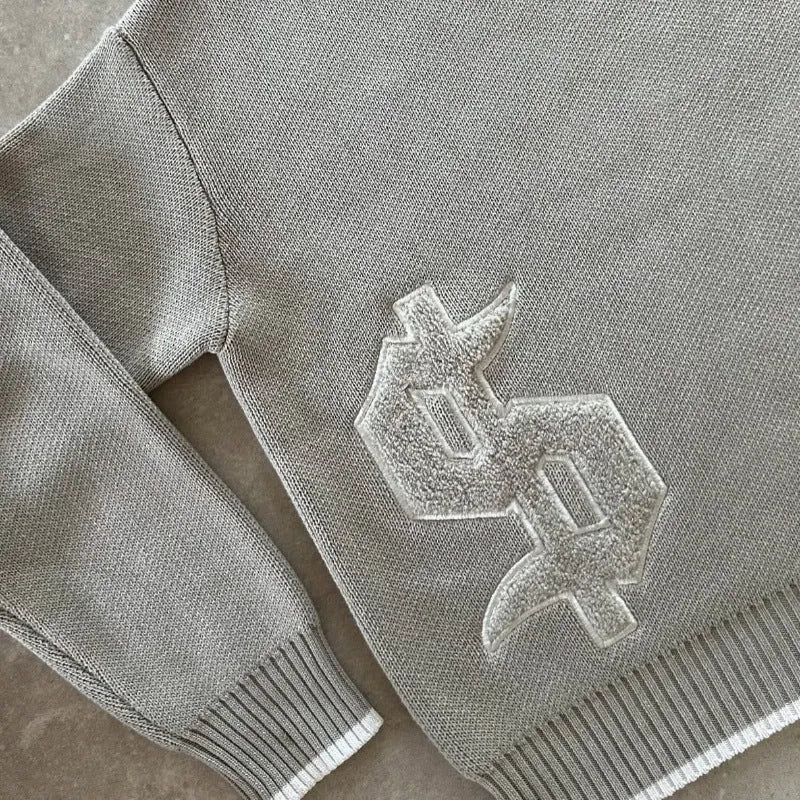 Grey jacquard loose-fitting knitwear coat with long sleeves on hanger
