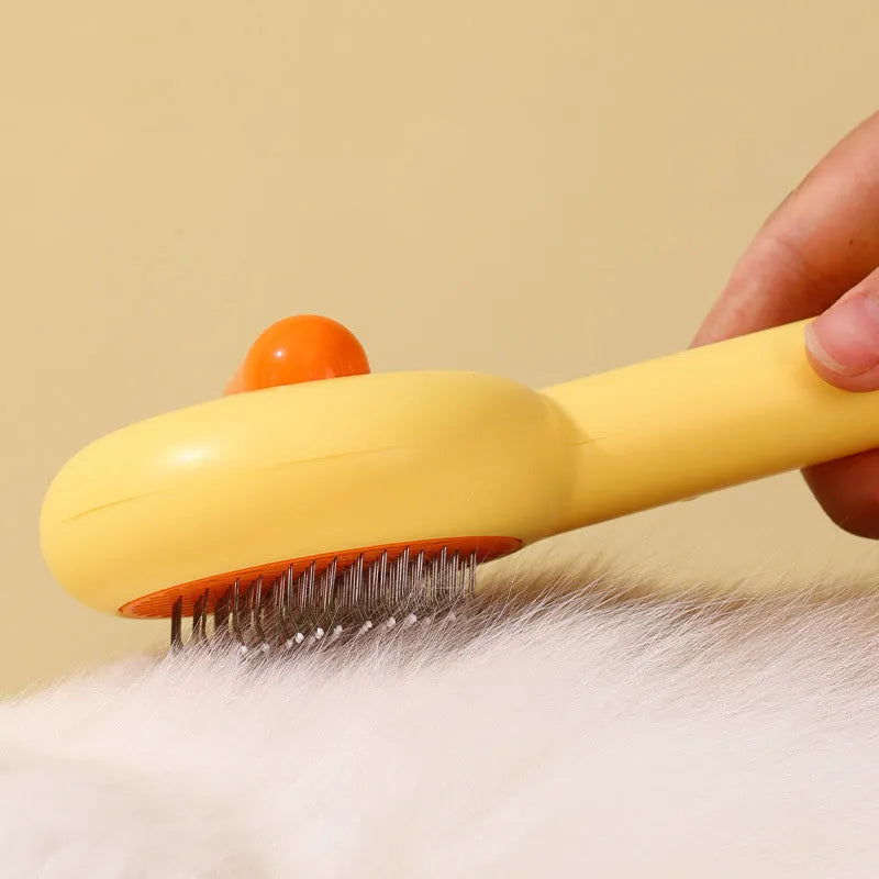 Small yellow duck-shaped pet grooming comb with needle head for hair removal on cats and dogs.