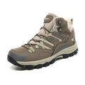Flannel upper hiking sneakers with rubber soles in light brown colour on a rocky path.