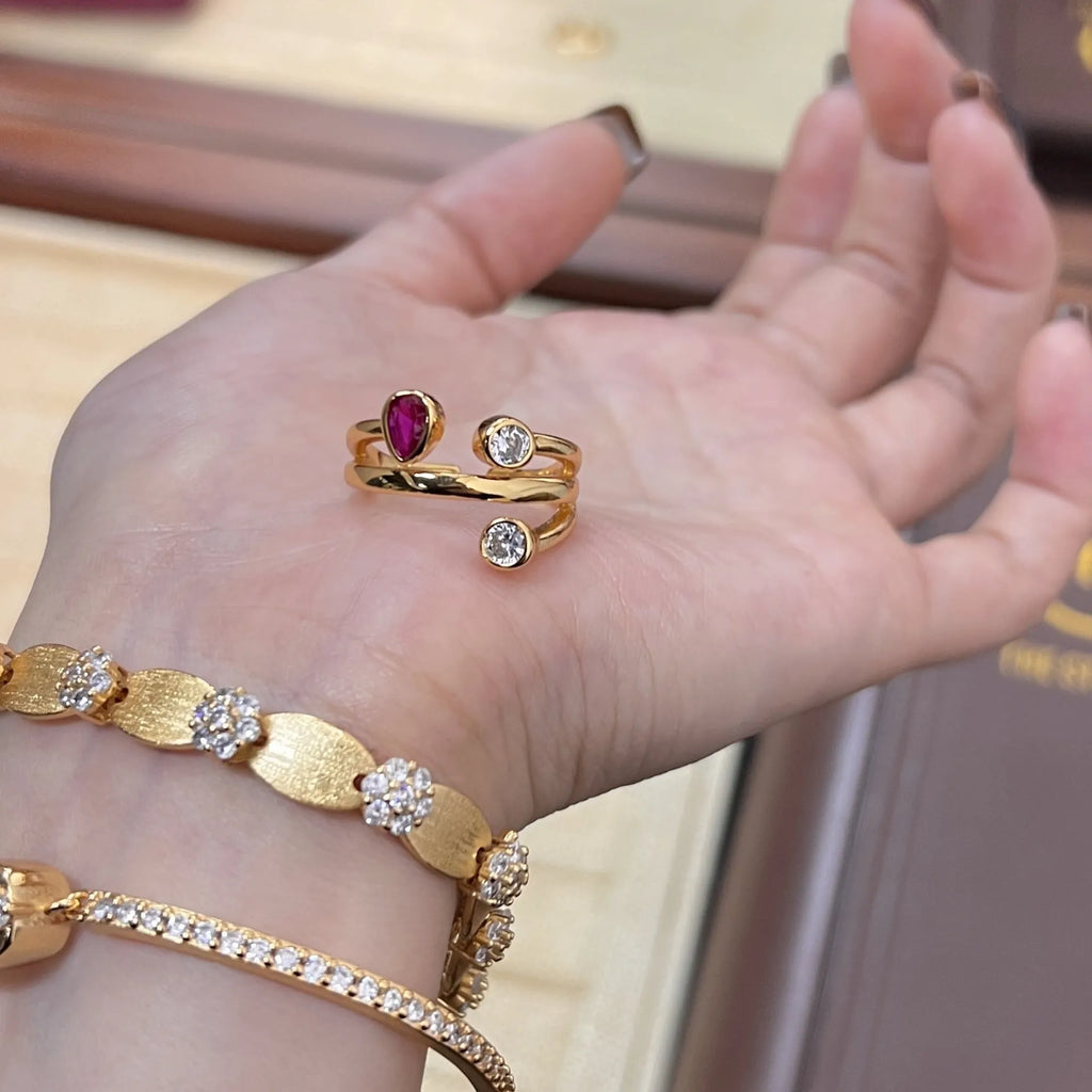 Geometric double-headed copper ring with irregular cross design and diamonds in two-tone colours.