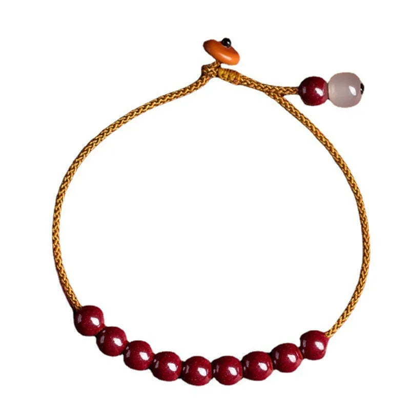 Hand-woven cinnabar and Hetian jade geometric bracelet on display