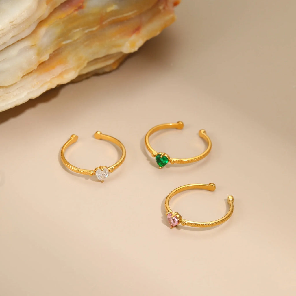 Open-ended heart-shaped ring with geometric design and zircon stones in stainless steel